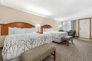 a hotel room with two beds and a chair at Best Western Plus Silver Saddle Inn in Estes Park +95 photos
