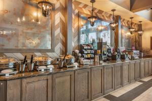 a restaurant with a counter with food on it at Best Western Plus Silver Saddle Inn in Estes Park