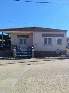 a white house with a fence in front of it at Xaris House in Ávaton