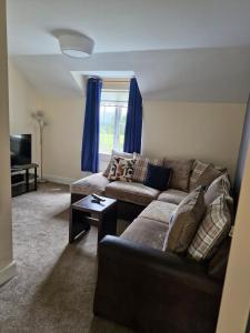 a living room with a couch and a table at Apartment in Coolea in Bard Inch