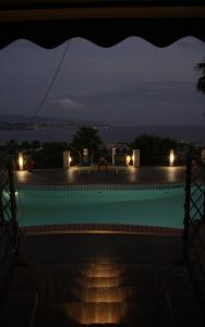 a swimming pool at night with lights at Sicily in Villa in Messina