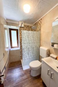 a bathroom with a toilet and a shower at House Flajs - secluded 2BR Surrounded by Forest in Soča