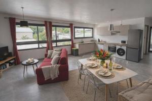 a living room with a couch and a table at La Kaz Sumac in Saint-Pierre