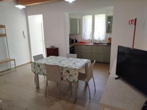 a kitchen with a table and chairs and a television at Da Zia Vecchia 1 in Cervia +8 photos