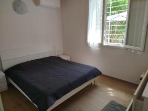 a bed in a white room with a window at Da Zia Vecchia 1 in Cervia
