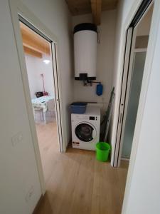 a laundry room with a washing machine and a table at Da Zia Vecchia 1 in Cervia