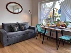 a living room with a couch and a table at Ferienwohnungen Boxler in Oberstdorf +25 photos