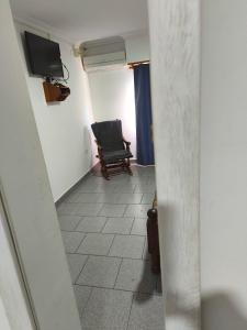 a hallway with a chair and a television in a room at Tesoro Escondido in Santa Rosa +3 photos