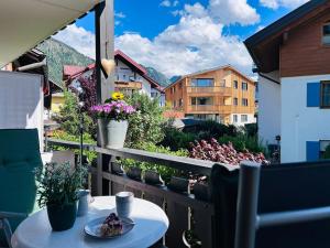 a balcony with a table and a view of a city at Ferienwohnungen Boxler in Oberstdorf