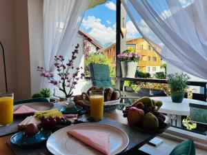 a breakfast table with a view of a balcony at Ferienwohnungen Boxler in Oberstdorf