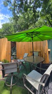 a table and chairs with a green umbrella at Grateful Hemphill in Atlanta