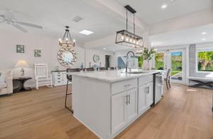 a kitchen with white cabinets and a white counter top at Poolside Palms - Team Joseph Ellen in Jacksonville Beach