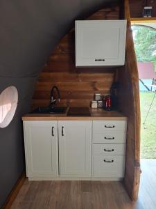 a kitchen with a sink and a counter top at Czarci Zakątek in Pozezdrze