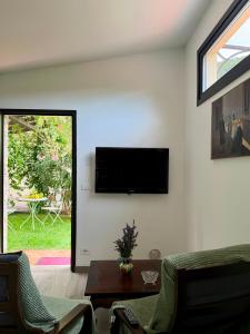 a living room with a flat screen tv on the wall at Dimora Pepatio in Camporosso
