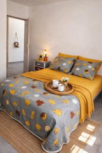 a bedroom with a bed with a tray of food on it at La Kaz Sumac in Saint-Pierre