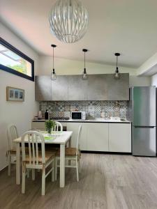 a kitchen with a table and a refrigerator at Dimora Pepatio in Camporosso
