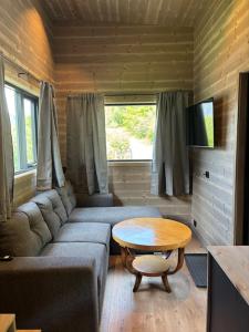 a living room with a couch and a table at Bjørgo Gard - Stegastein in Aurland