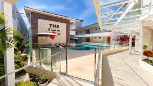 an external view of a building with a swimming pool at THE - Tropicanas Hotel e Eventos in Florianópolis +27 photos