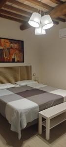 a bedroom with two beds and a chandelier at Sotto l'Ulivo in Mondavio +37 photos