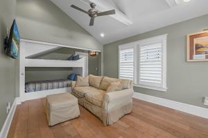a living room with a couch and a bunk bed at Riberia Columbus Cottage - Team Joseph Ellen in St. Augustine