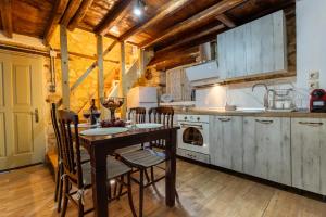 a kitchen with a table and chairs in a room at Stefanos House in Afitos