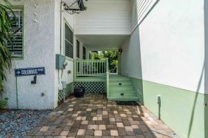 a front porch of a house with a green dresser at Riberia Columbus Cottage - Team Joseph Ellen in St. Augustine +41 photos