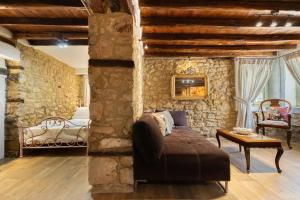 a living room with a couch and a bedroom at Stefanos House in Afitos