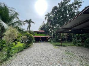 a house with a gravel road in front of it at Cozy cabin by the sea in Cahuita