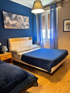 a bedroom with two beds and a blue wall at hotel Bologna in Fanano