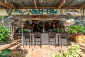 a bar with chairs in front of a restaurant at Saint Johns Oasis - Pool Hot Tub Grill in Jacksonville