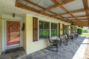 a porch with a row of chairs on a house at Saint Johns Oasis - Pool Hot Tub Grill in Jacksonville +88 photos