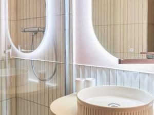 a bathroom with a sink and a mirror at ibis Avignon Centre Gare in Avignon +35 photos