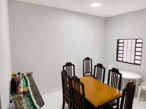 a dining room with a wooden table and chairs at Hotel Goldem Park in Brasília