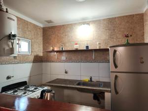 a kitchen with a refrigerator and a sink at Tesoro Escondido in Santa Rosa