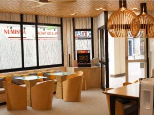 a fast food restaurant with tables and chairs at ibis Styles Caen Centre Historique in Caen
