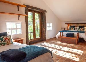 a bedroom with two beds and a large window at Comfortable lakeside house! in Güéjar-Sierra +16 photos