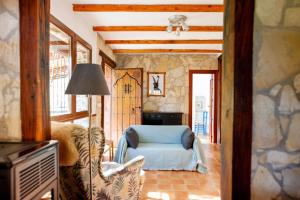 a living room with a chair and a lamp at Comfortable lakeside house! in Güéjar-Sierra