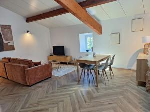 a living room with a couch and a table at Les Gites de la Bastide in Ribes