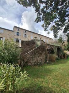 a stone building with a bridge in front of it at Les Gites de la Bastide in Ribes