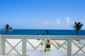 a bottle of wine sitting on a table on the beach at La Casita Azul in Punta de Mujeres