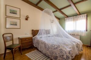 a bedroom with a bed with a mosquito net at El Leñador I in Hoyos del Espino