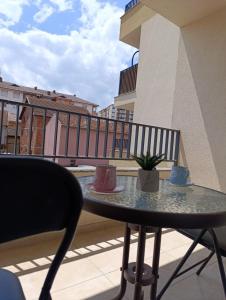 a table and a chair on a balcony at Apartman Vida in Novi Pazar