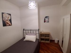 a small bedroom with a bed and a night stand at Suite Isernia Centro in Isernia