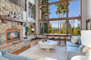 a living room with a large stone fireplace at Trailside Lodge in Cle Elum