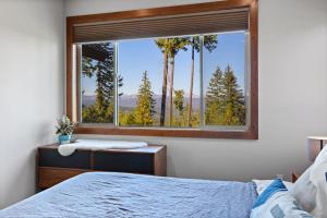 a bedroom with a window with a view of trees at Trailside Lodge in Cle Elum