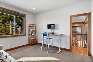 a room with a desk with a computer and a window at Trailside Lodge in Cle Elum