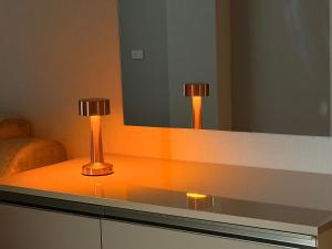 two lamps on a counter in front of a mirror at Bea Paradise 113 in Baku +30 photos