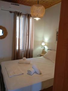 a bedroom with a bed with two towels on it at Blue Sea Suite Avlakia in Avlákia
