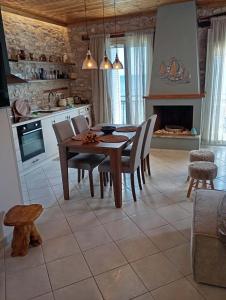 a kitchen and dining room with a table and chairs at Blue Sea Suite Avlakia in Avlákia