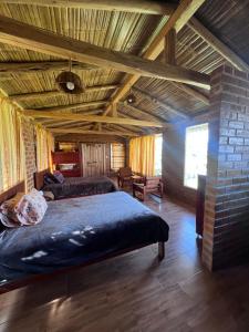 a bedroom with a large bed with a wooden ceiling at Refugio del venado familiar in Cotacachi